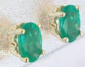 Oval cut solitaire natural emerald earrings in 14k yellow gold