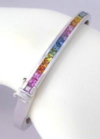Princess cut rainbow sapphire bangle bracelet in 14k white gold, featuring vibrant channel-set sapphires.