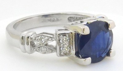 8mm round natural blue sapphire engagement ring with diamond accents in 14k white gold, featuring three matching bands.