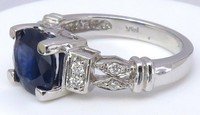 8mm round blue sapphire engagement ring with diamond accents in 14k white gold, featuring three matching band options.