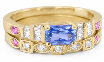 Radiant cut blue sapphire engagement ring with pink sapphires and baguette diamonds in 14k yellow gold setting.